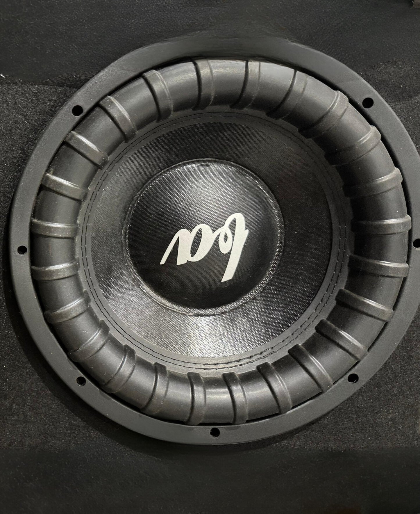 Car subwoofer with a brand logo on a black background