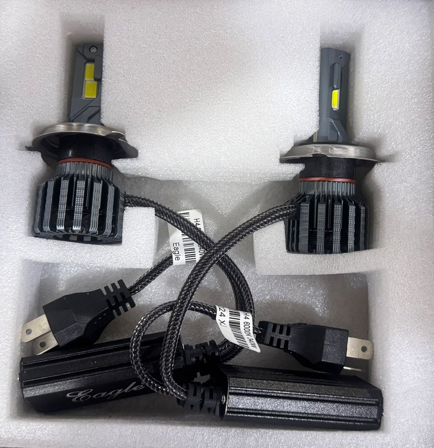 Two car headlight bulbs with wiring in a foam packaging