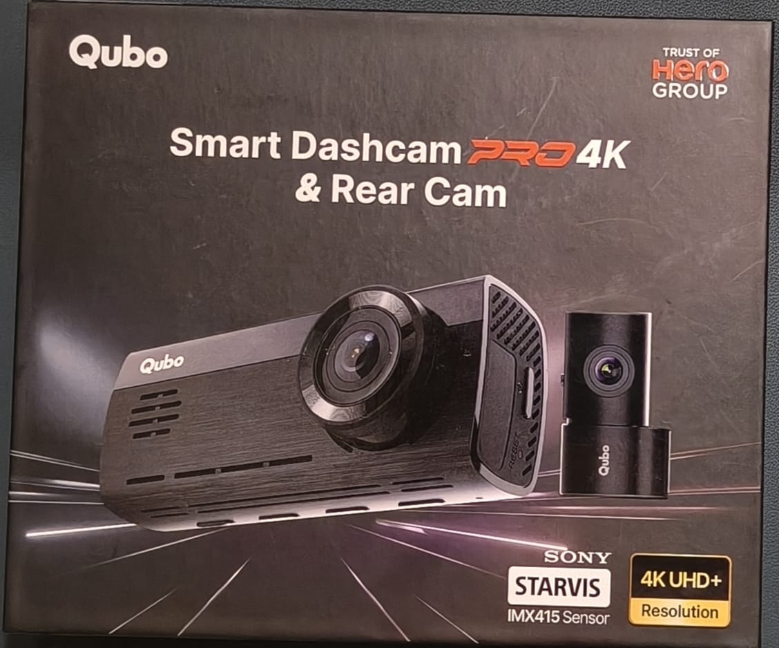 Qubo Smart Dashcam Pro 4K & Rear Cam packaging with camera images on a dark background