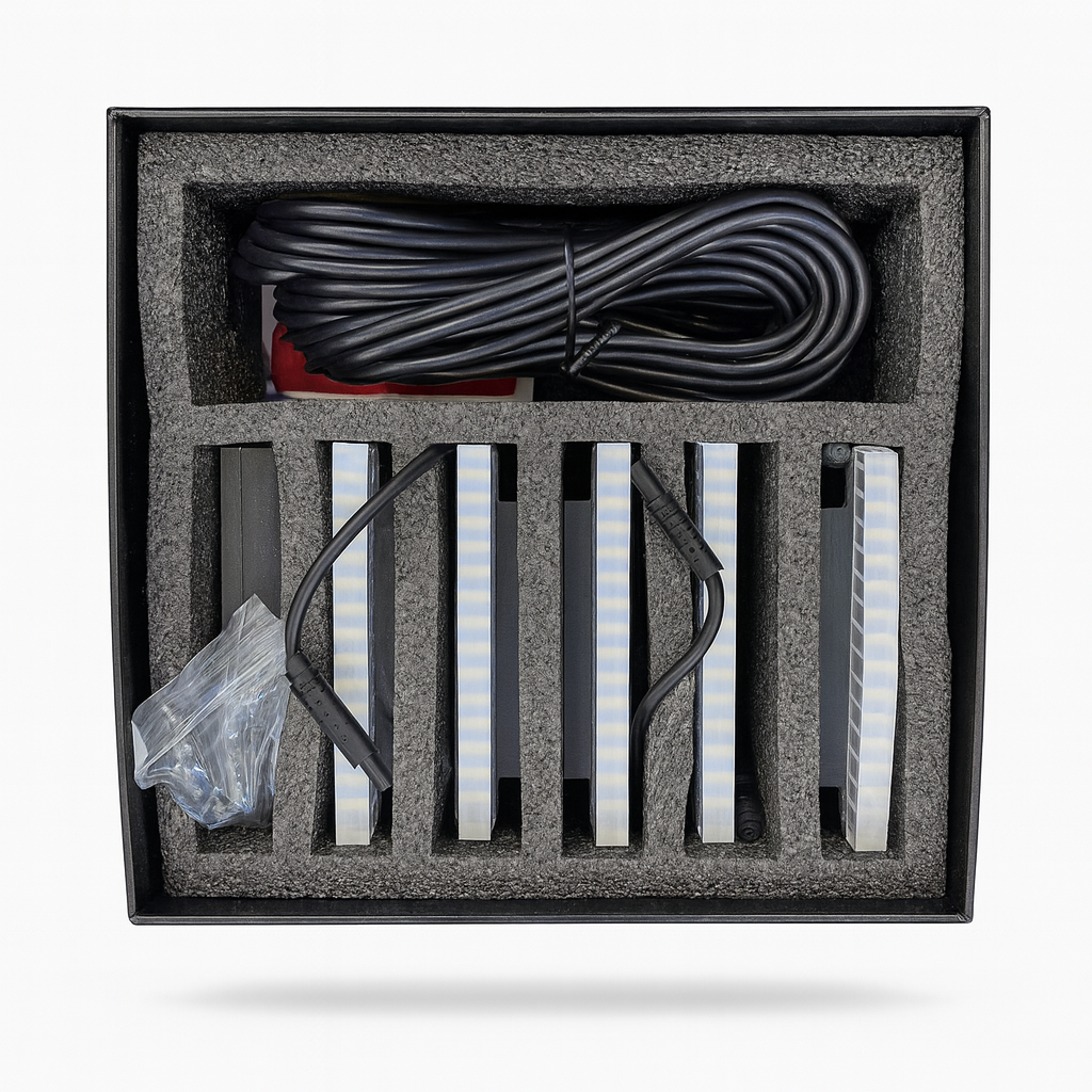 Packaged electronic components including cables and LED strips on a white background