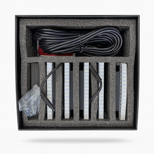 Packaged electronic components including cables and LED strips on a white background