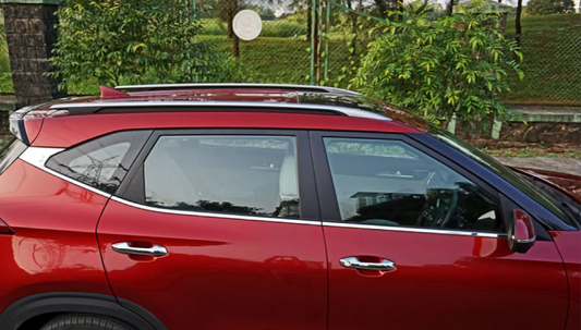 Red car with a roof rack in an outdoor setting