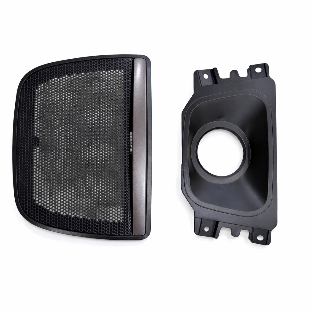 Black mesh grille and speaker component on a white background