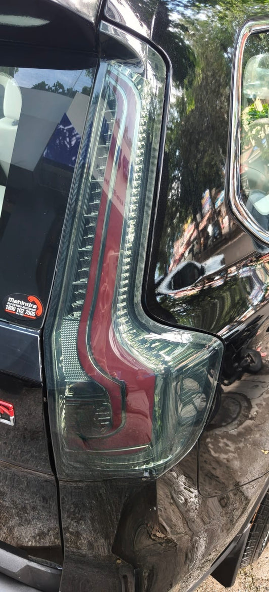 Car headlight with visible brand logo on a vehicle