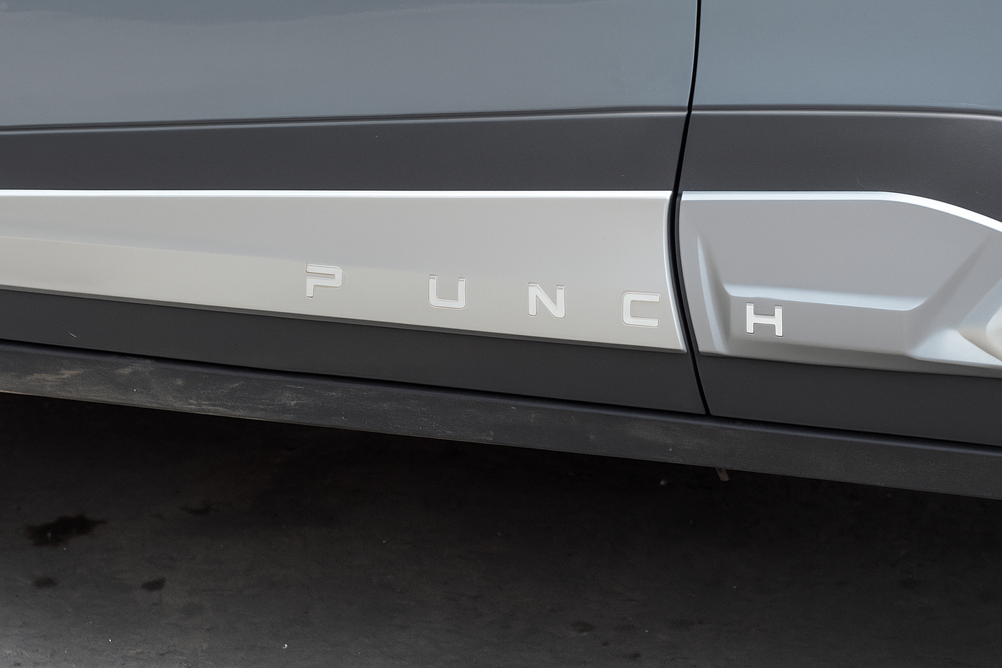 Car door with 'PUNCH' branding on a dark background