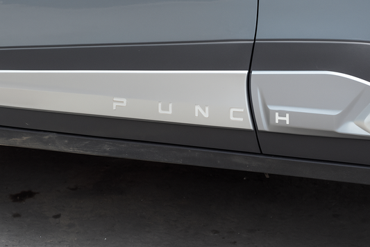 Car door with 'PUNCH' branding on a dark background