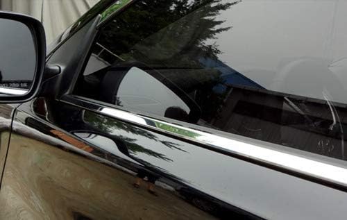 Close-up of a car's side mirror and chrome door handle.