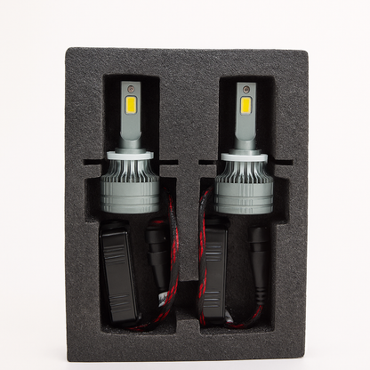 Two car LED headlights in a black foam packaging on a white background