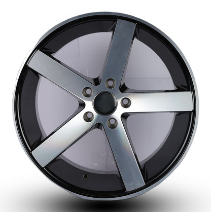 Car wheel rim with black and silver finish on a white background