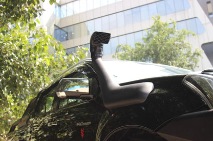 Car with a roof-mounted camera system in an urban setting
