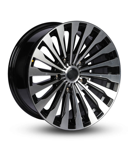 Glossy black car wheel rim on a white background