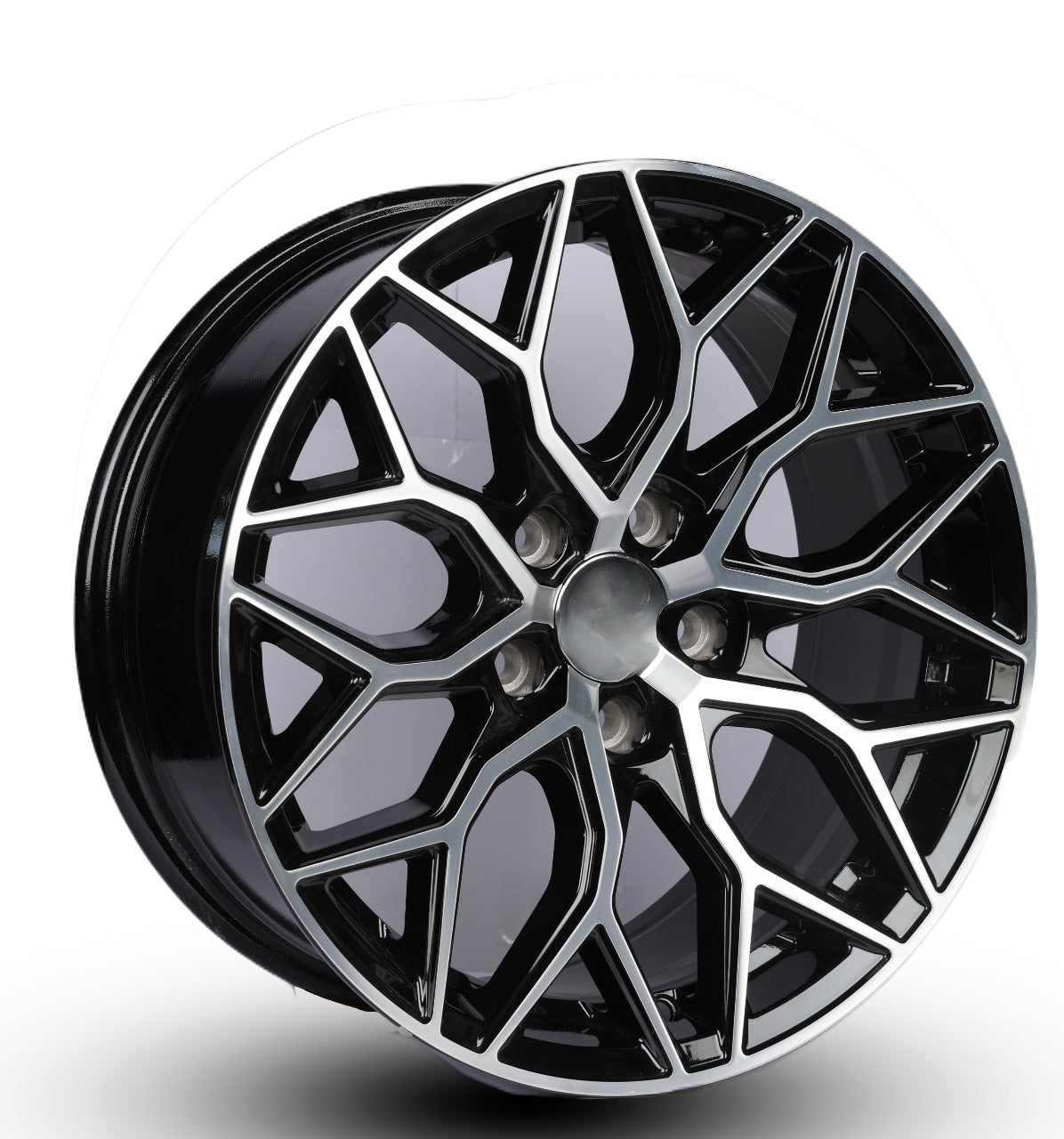 Black alloy wheel with geometric design on a white background