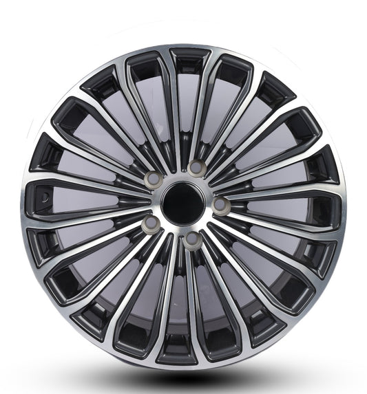 Car wheel rim with black and silver design on a white background