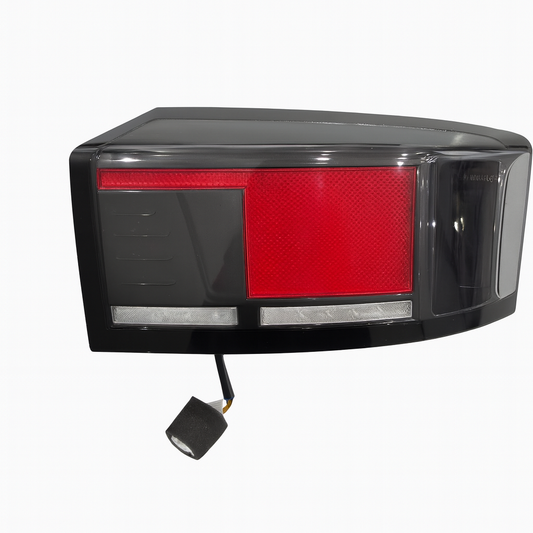 Tail light assembly with red reflector and black casing on a white background