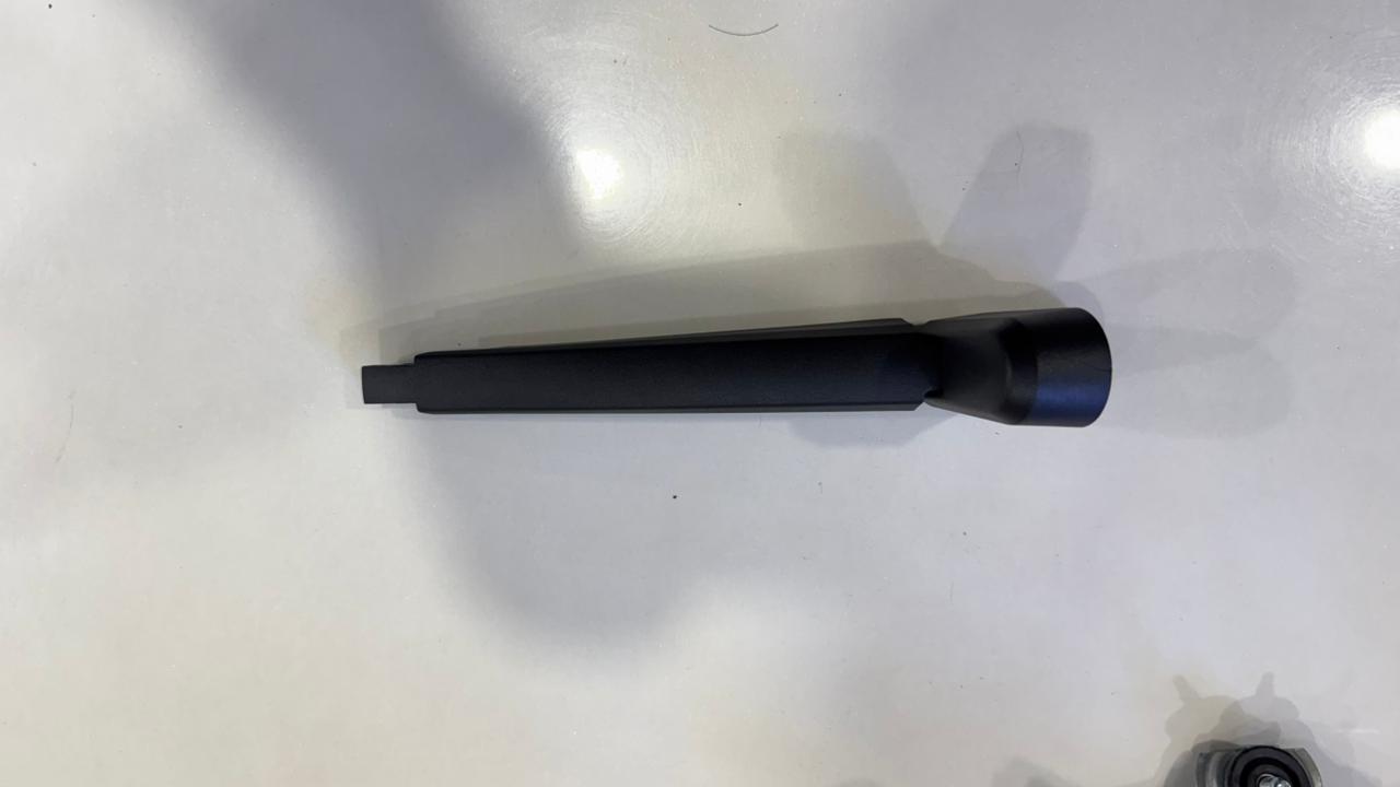 Black cylindrical object on a white surface