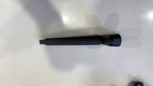 Black cylindrical object on a white surface