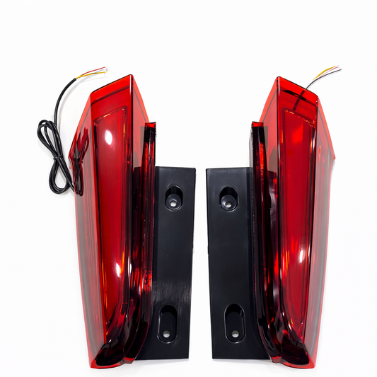 Pair of red tail lights with black mounting brackets on a white background