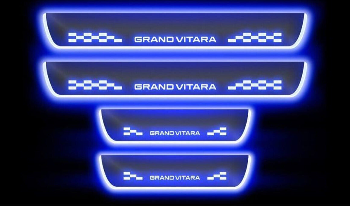 Set of four illuminated door sill protectors with 'Grand Vitara' branding on a black background.