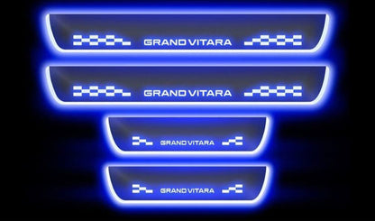 Set of four illuminated door sill protectors with 'Grand Vitara' branding on a black background.