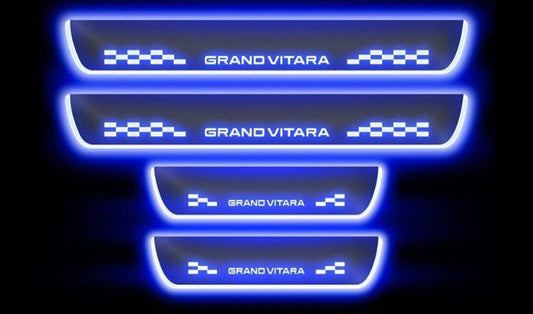 Set of four illuminated door sill protectors with 'Grand Vitara' branding on a black background.
