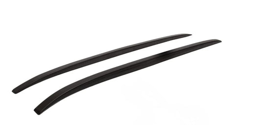 Two black car roof racks on a white background