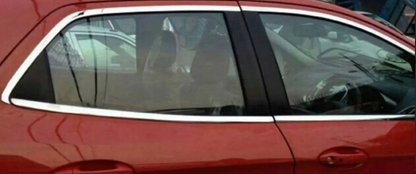 Red car with a person inside, partially obscured by a window shade.