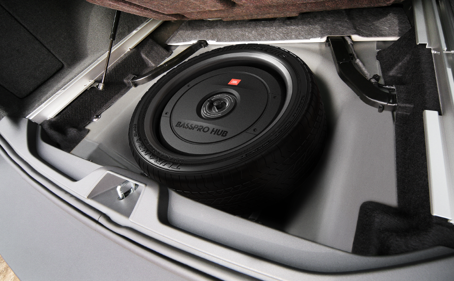Car subwoofer installed in a vehicle's floor panel.
