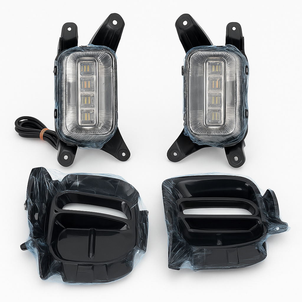 Four car fog lights with clear covers on a white background