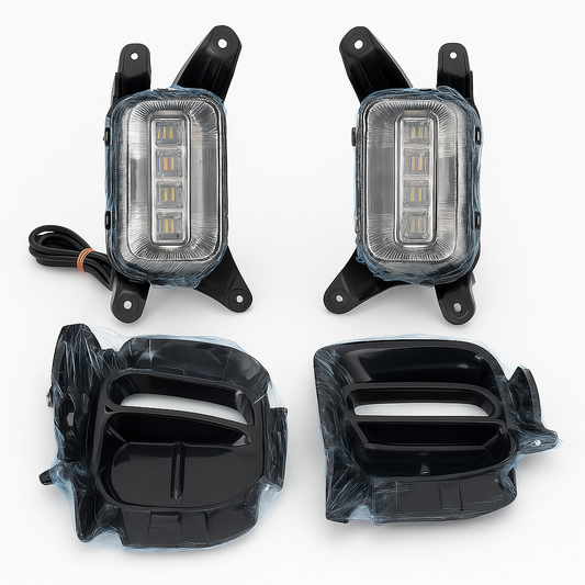 Four car fog lights with clear covers on a white background