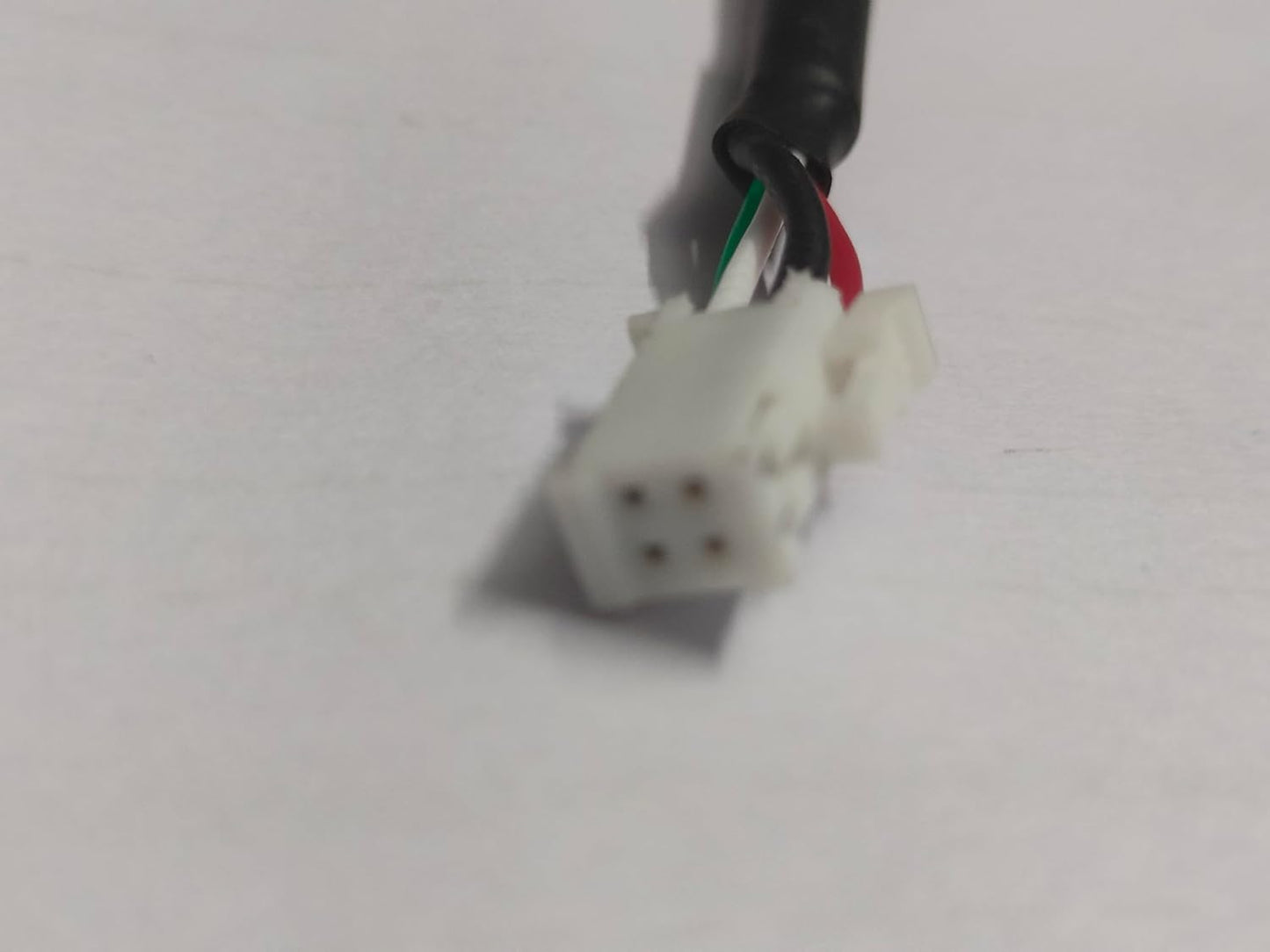 Close-up of a wiring connector with colored wires on a white background