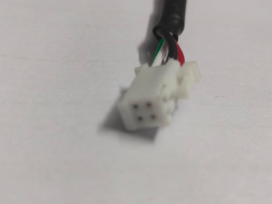 Close-up of a wiring connector with colored wires on a white background