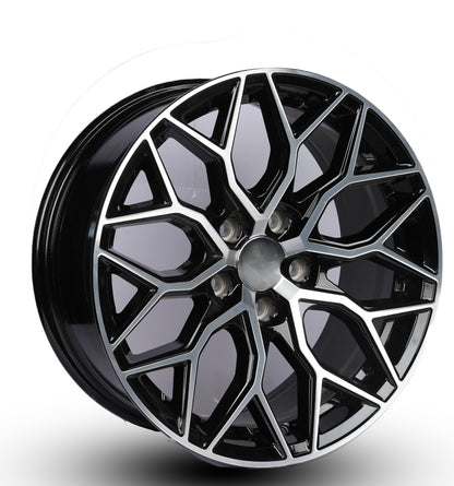 Black alloy wheel with geometric design on a white background