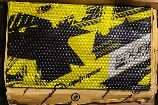 Box of golf balls with a yellow and black star design on the lid.
