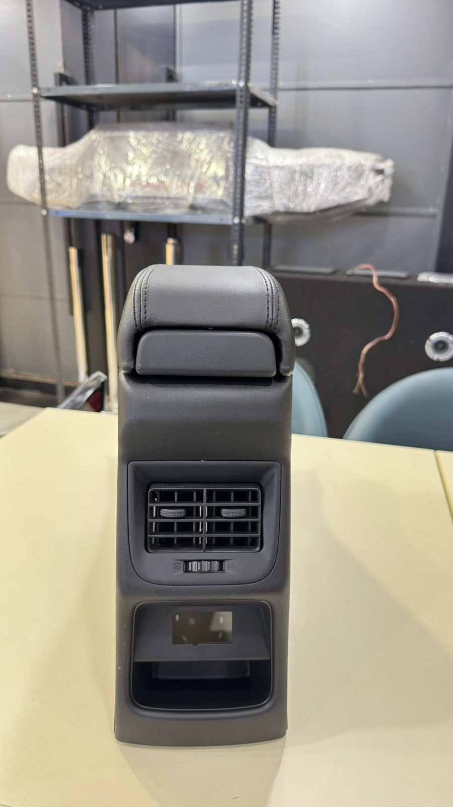 Car headrest with air vents on a table, blurred background