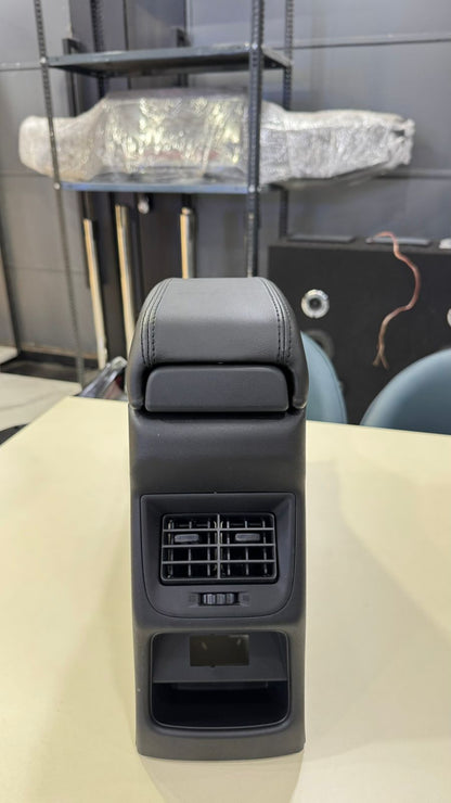 Car seat armrest with cup holder and air vent on a table