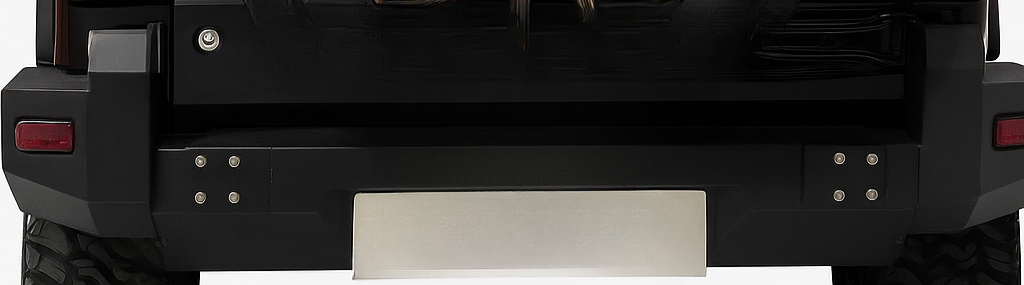 Black vehicle bumper with a metallic plate on a white background
