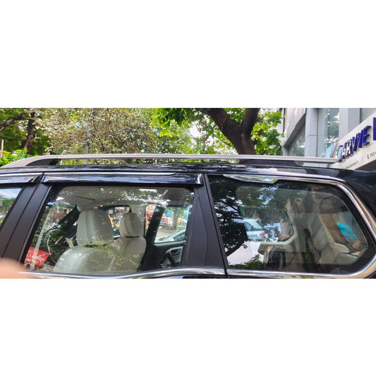 Car window with a view of a city street and trees