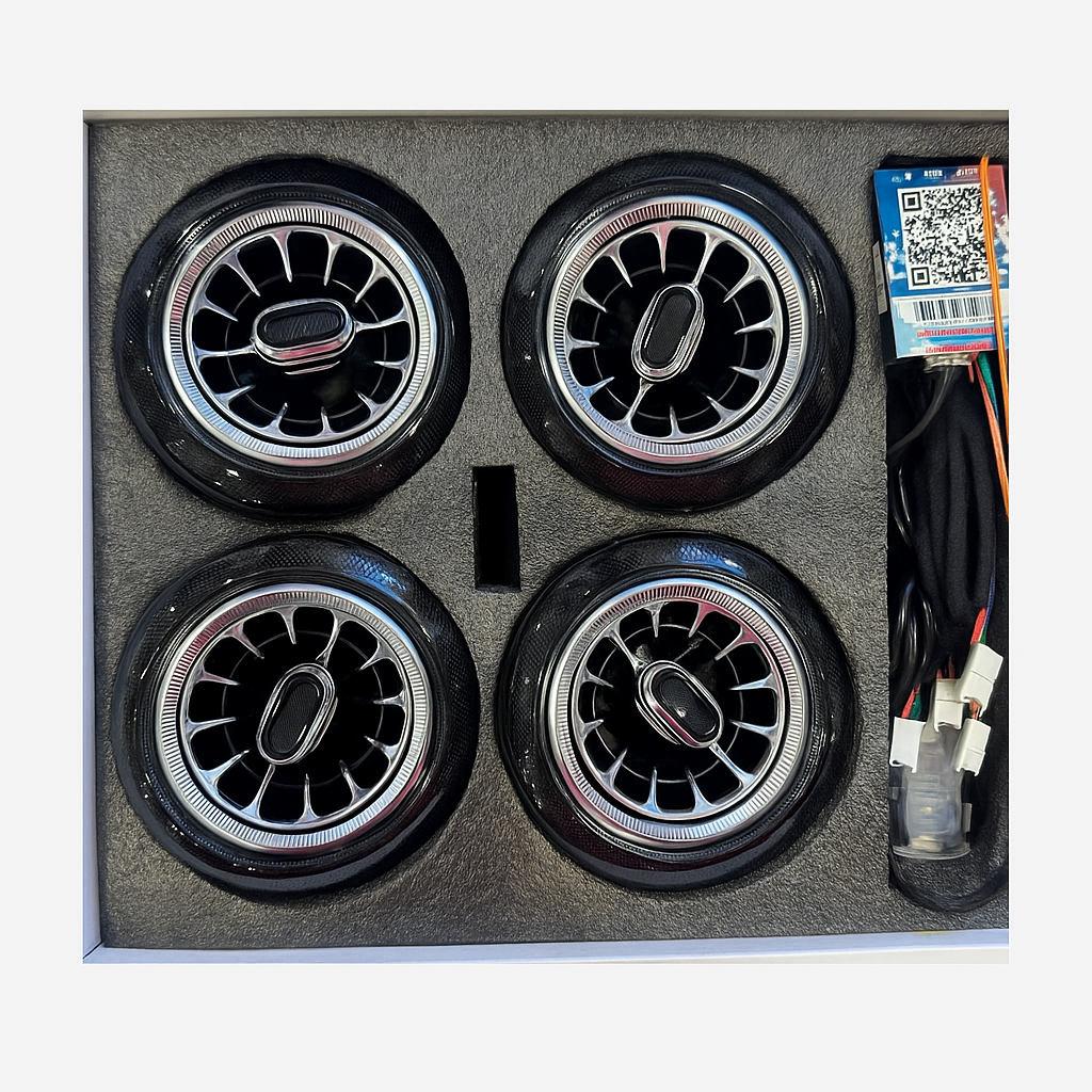 Four car wheels in a box with wiring and a QR code label.