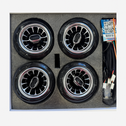 Four car wheels in a box with wiring and a QR code label.