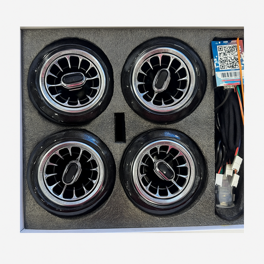 Four car wheels in a box with wiring and a QR code label.