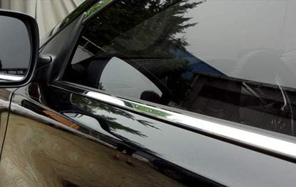 Close-up of a car's side mirror and chrome door handle.