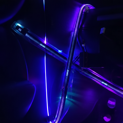 Car interior with LED strip lights illuminating the dashboard and door panel.